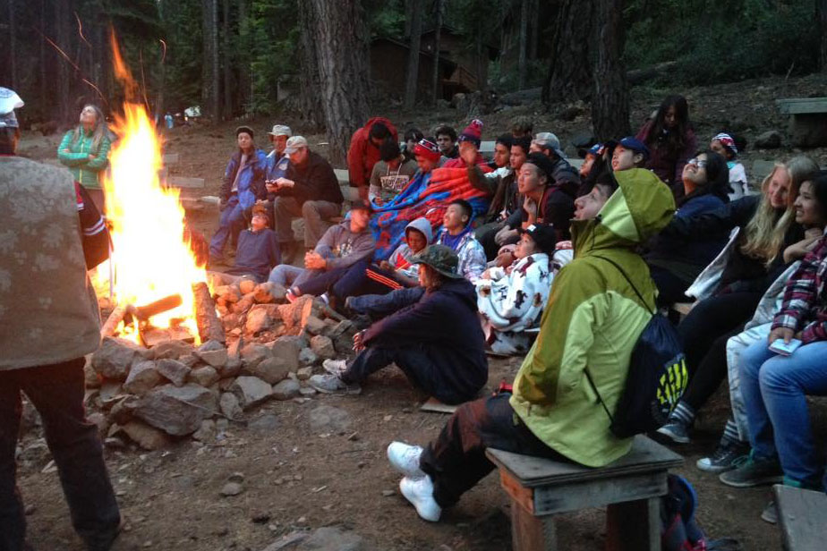 Students sitting around a bonfire